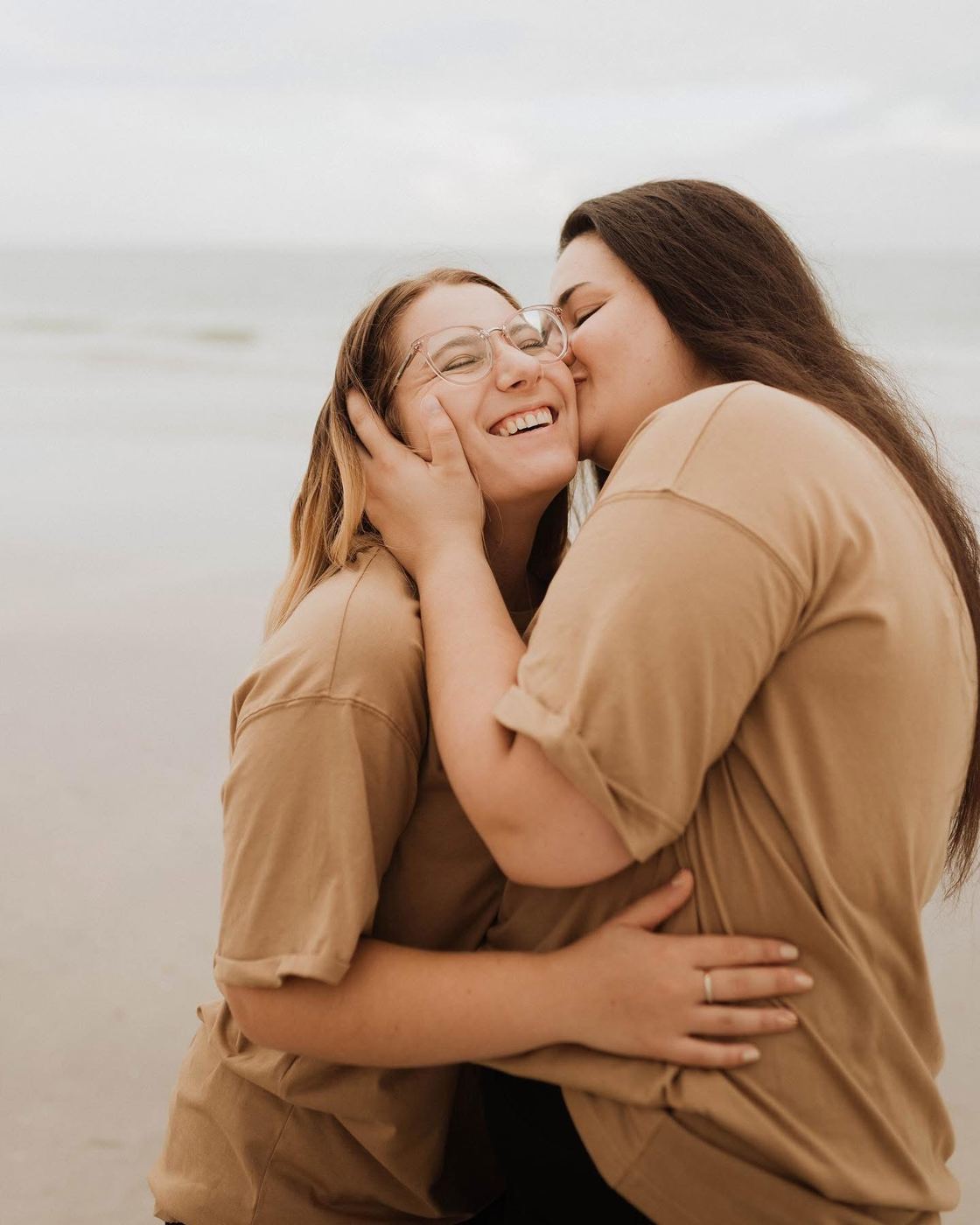 Couple laughing and embracing on a beach