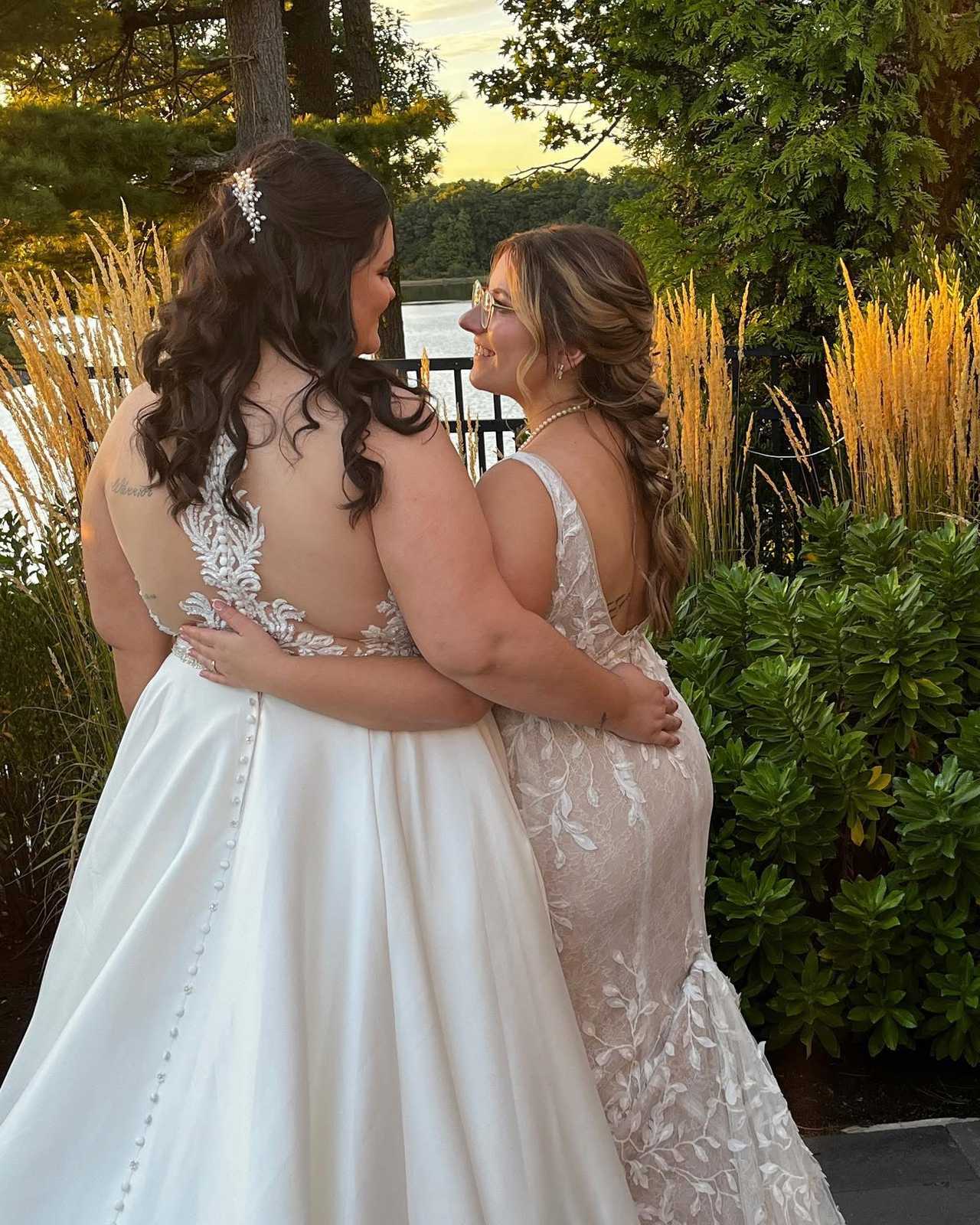 Newlywed couple sharing a warm moment beside a lakeside garden